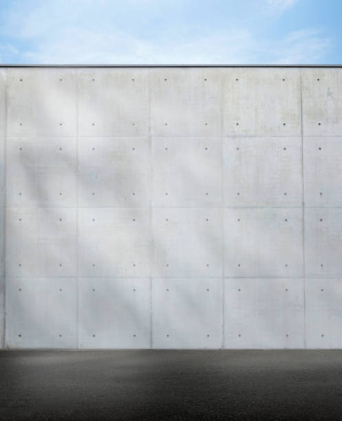 istock perfect concret wall outside on a sunny day with sun spots 1496885396