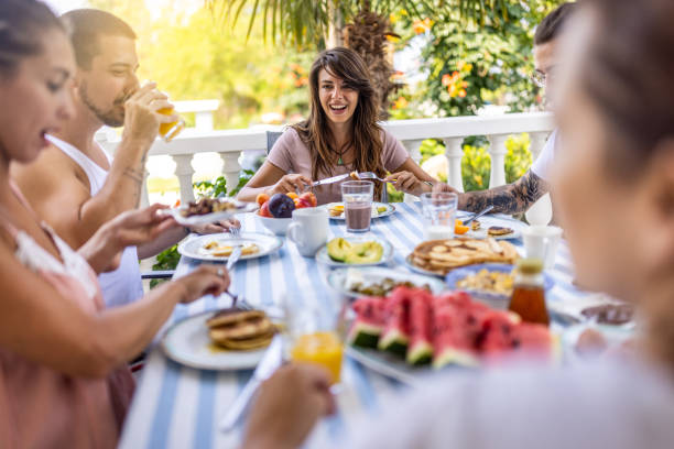 istock Friends eating fresh breakfast at balcony 1496886622