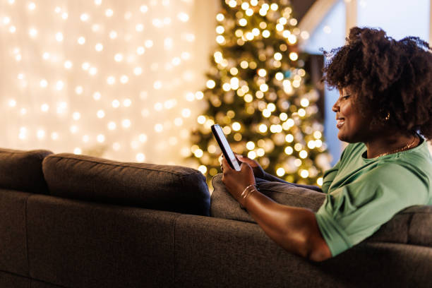 istock Young woman relaxing on the sofa and using smart phone 1496886660