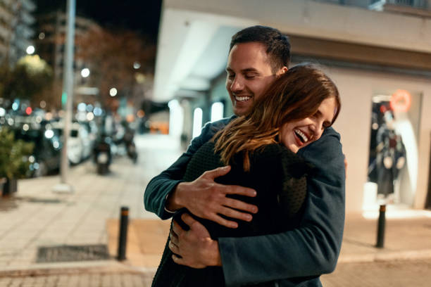 istock Smiling couple hugging on the street 1496886803