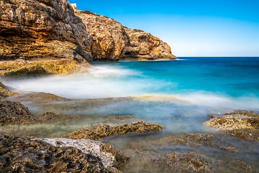 A tranquil scene of the blue sea and coastal cliffs. Cala Magrana, Mallorca, Spain.