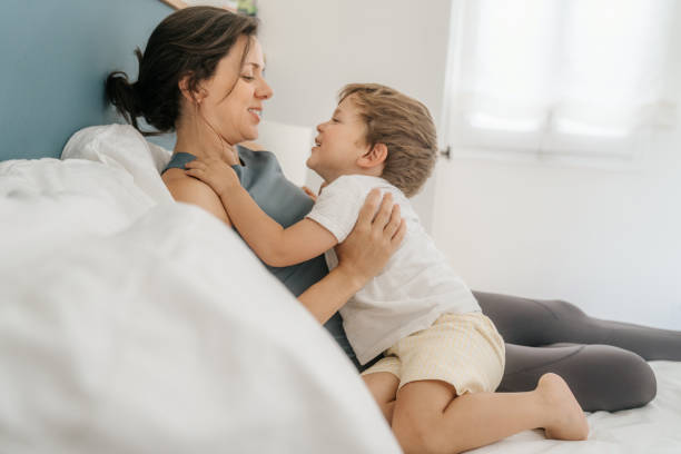 istock Mother playing with her son on bed 1496887877