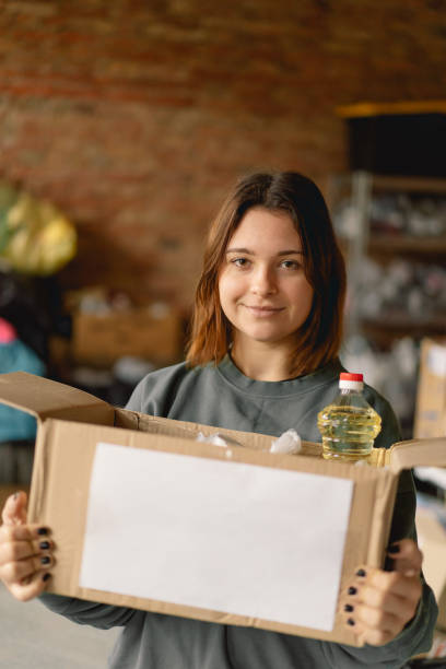 istock Volunteer teengirl preparing donation boxes for people 1496888620