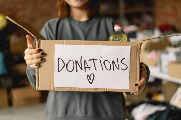 istock Volunteer teengirl preparing donation boxes for people 1496888646