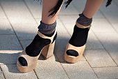 Close up Female legs in socks and open toed sandals on high heels. Stylish clothes and shoes. Trend fashion style