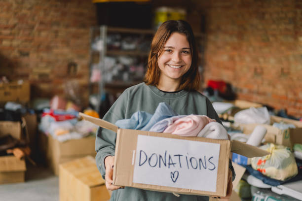 istock Volunteer teengirl preparing donation boxes for people 1496888683