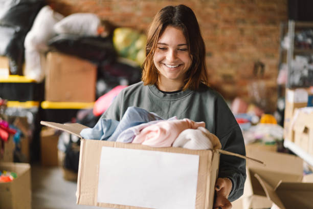 istock Volunteer teengirl preparing donation boxes for people 1496888689