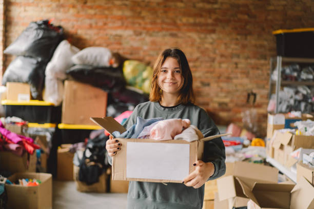 istock Volunteer teengirl preparing donation boxes for people 1496888713