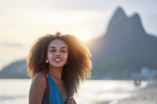 headshot portrait young black brazilian woman posing on the shore of Ipanema beach in Brazil