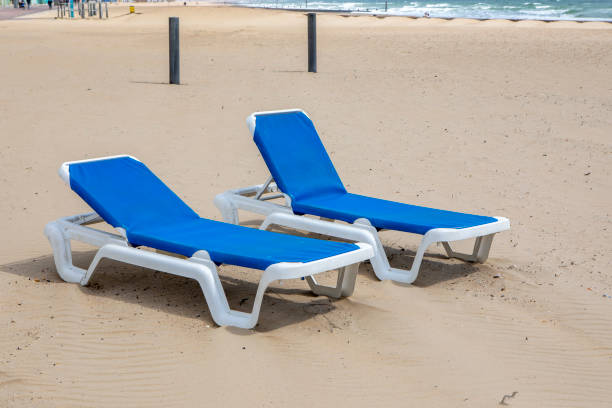 istock Two sun loungers on a beach 1496893239