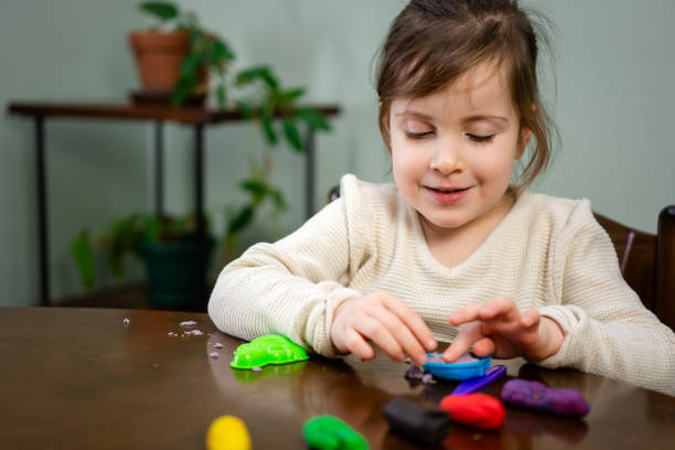 istock Child playing whit clay at home 1496893522