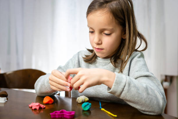 istock Child playing whit clay at home 1496893547