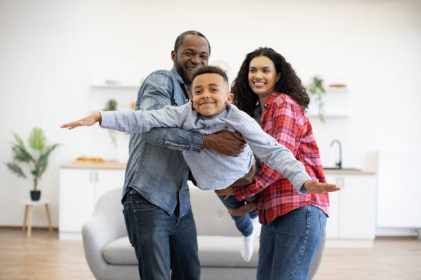 istock Kid testing flight thanks to parents in lounge at home 1496893641