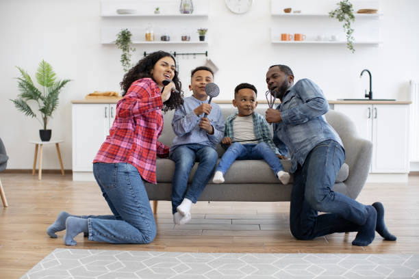 istock Parents and sons singing with kitchen utensils at home 1496893655