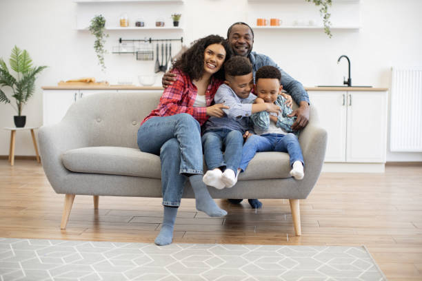 istock Brothers and parents relaxing on couch in kitchen on weekend 1496893727