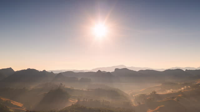 Aerial view of a beautiful morning scene with fog and mist on high mountains