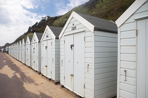Closed beach huts on the promenade by the beach between Bournemouth and Poole, England