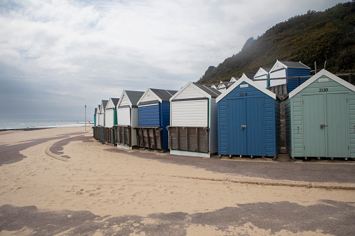 Closed beach huts on the promenade by the beach between Bournemouth and Poole, England