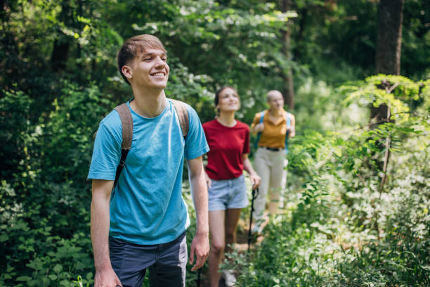 istock Three friends hiking in the forest and enjoying nature 1496895485