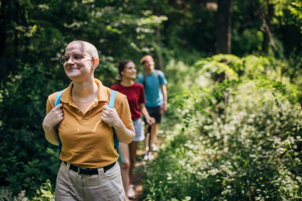 istock Three friends hiking in the forest and enjoying nature 1496896076