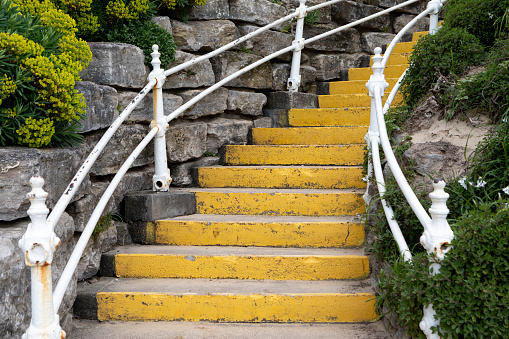 Yellow coloured steps leading down to the beach, Bournemouth, England