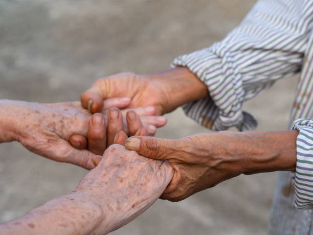 istock Close-up of shaking hands between senior women. 1496896754