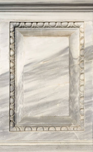 An empty flat surface of white marble with an ornamental frame. Blank background from a monument to include a text or image