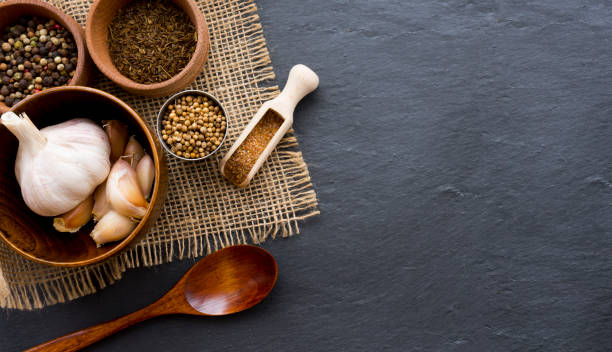 istock Various spices in wooden bowls on a dark table 1496898036