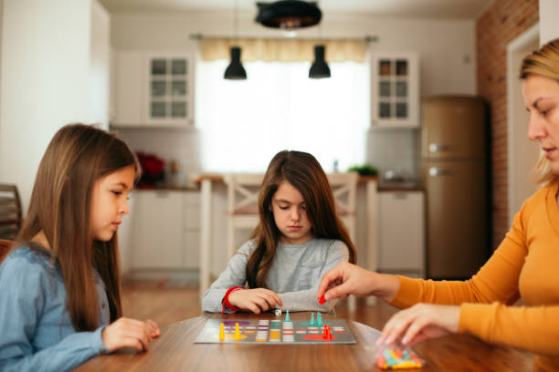 istock Family playing board game on the table 1496898413
