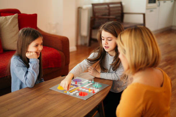 istock Family playing board game on the table 1496898535