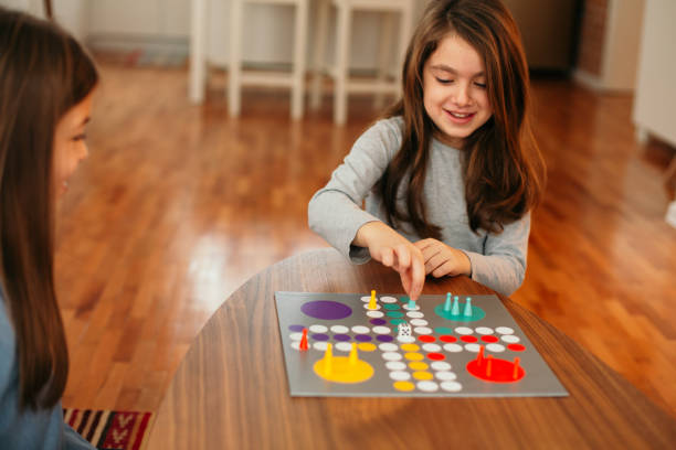 istock Two children having fun playing board game on the table at home 1496899515
