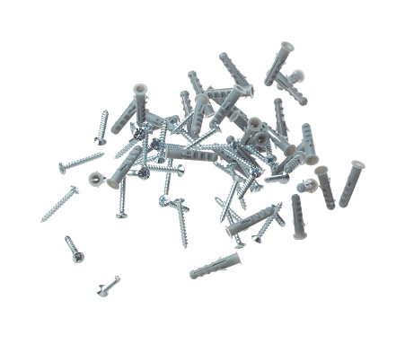 Flying Plastic gray dowel and screw in air. Expansion anchors, fixing dowel with chromed screw. Many pair of screw and dowel anchors floating in group. White background isolated