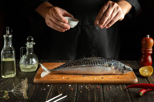 istock A fish chef prepares fresh mackerel in the kitchen. Scomber must be salted before baking. European cuisine. 1496899622
