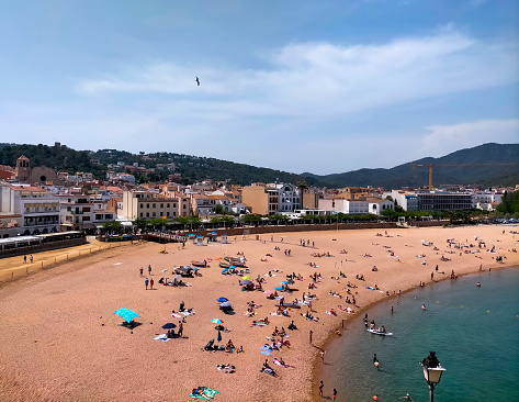 views of the beach in the center of Tossa de Mar with unrecognizable bathers. Image taken from Vila Vella de Tossa (aerial view). Costa Brava, Girona.