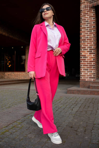 istock Woman walking me in a bright pink suit 1496902936