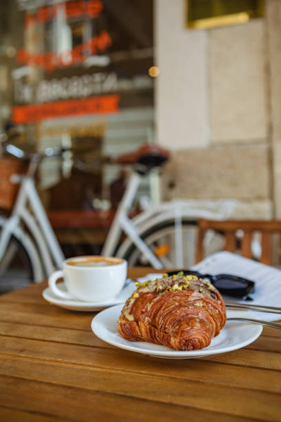 istock Breakfast time with croissant, coffee, and magazine 1496904540