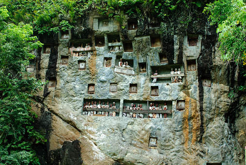 Graves in the rock with puppets in Sulawesi, Indonesia