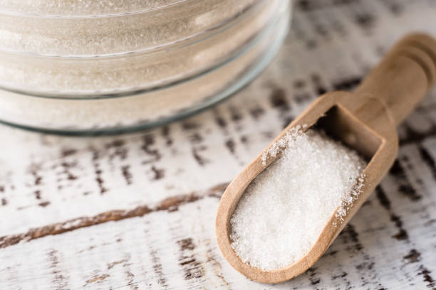istock sugar in a wooden spoon closeup, macro. 1496910402