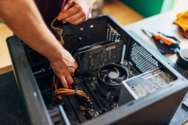 Close-up of the computer tower and the hands of a man trying to find the problem and fix the computer Unrecognizable man fixing broken computer at home, trying to solve problem in computer tower computer case stock pictures, royalty-free photos & images