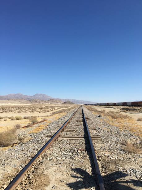 istock Vertical shot of a train track stretching through a desert landscape 1496911542