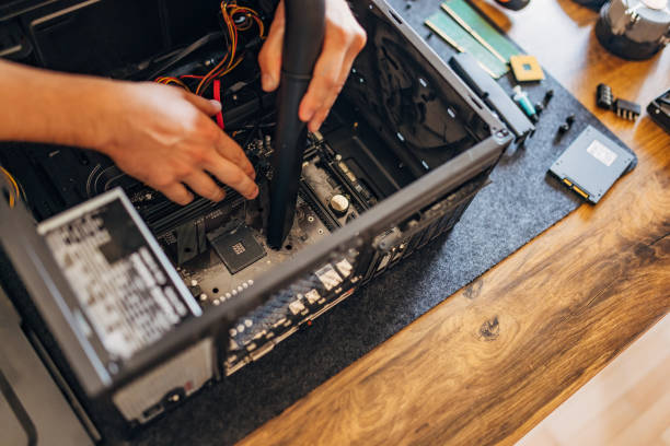 istock Close-up of a man vacuuming dust and dirt in a computer case 1496912664