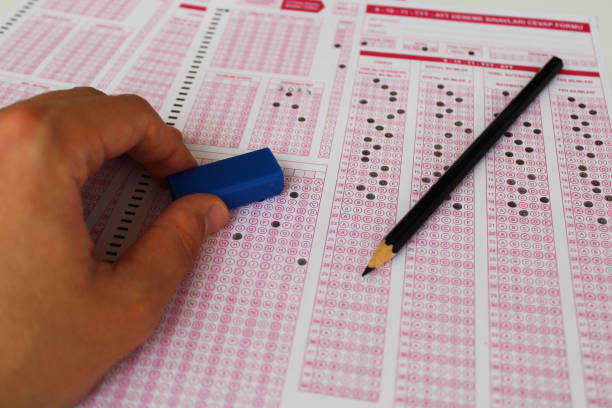 istock Exam, a hand taking a test with a pencil over an optical reader. Future Anxiety. Uncertainty. 1496913096