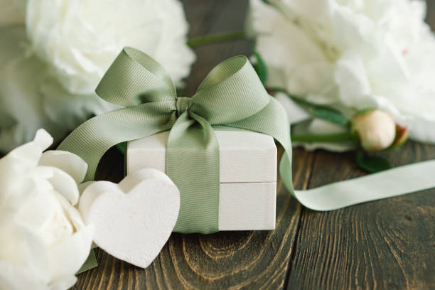 istock Bouquet of beautiful white peonies with gift boxes 1496913440