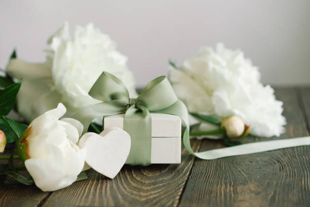 istock Bouquet of beautiful white peonies with gift boxes 1496913441