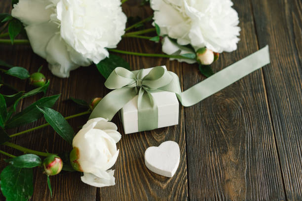 istock Bouquet of beautiful white peonies with gift boxes 1496913453