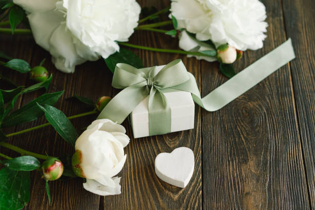 istock Bouquet of beautiful white peonies with gift boxes 1496913456