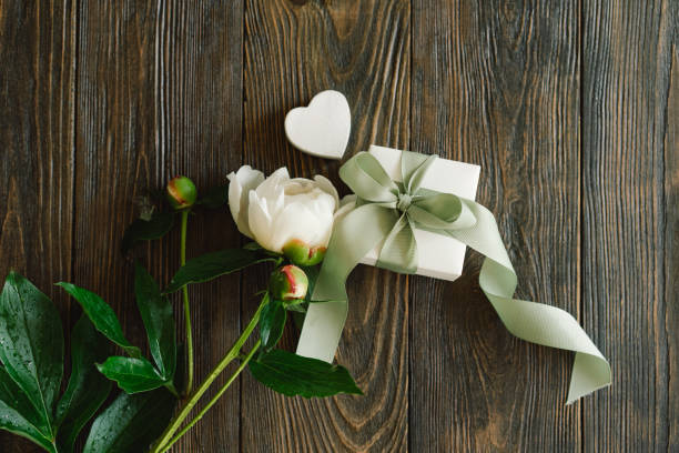 istock Bouquet of beautiful white peonies with gift boxes 1496913465