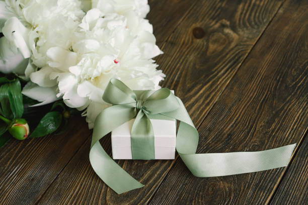istock Bouquet of beautiful white peonies with gift boxes 1496913496