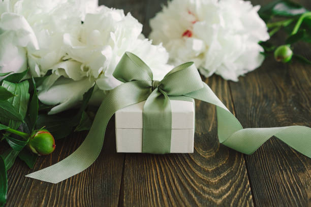 istock Bouquet of beautiful white peonies with gift boxes 1496913947