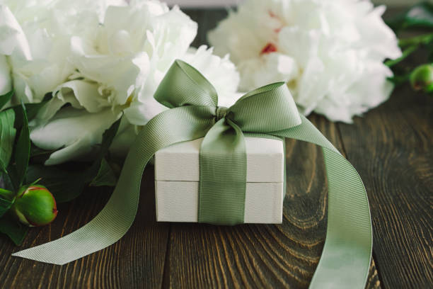 istock Bouquet of beautiful white peonies with gift boxes 1496914013